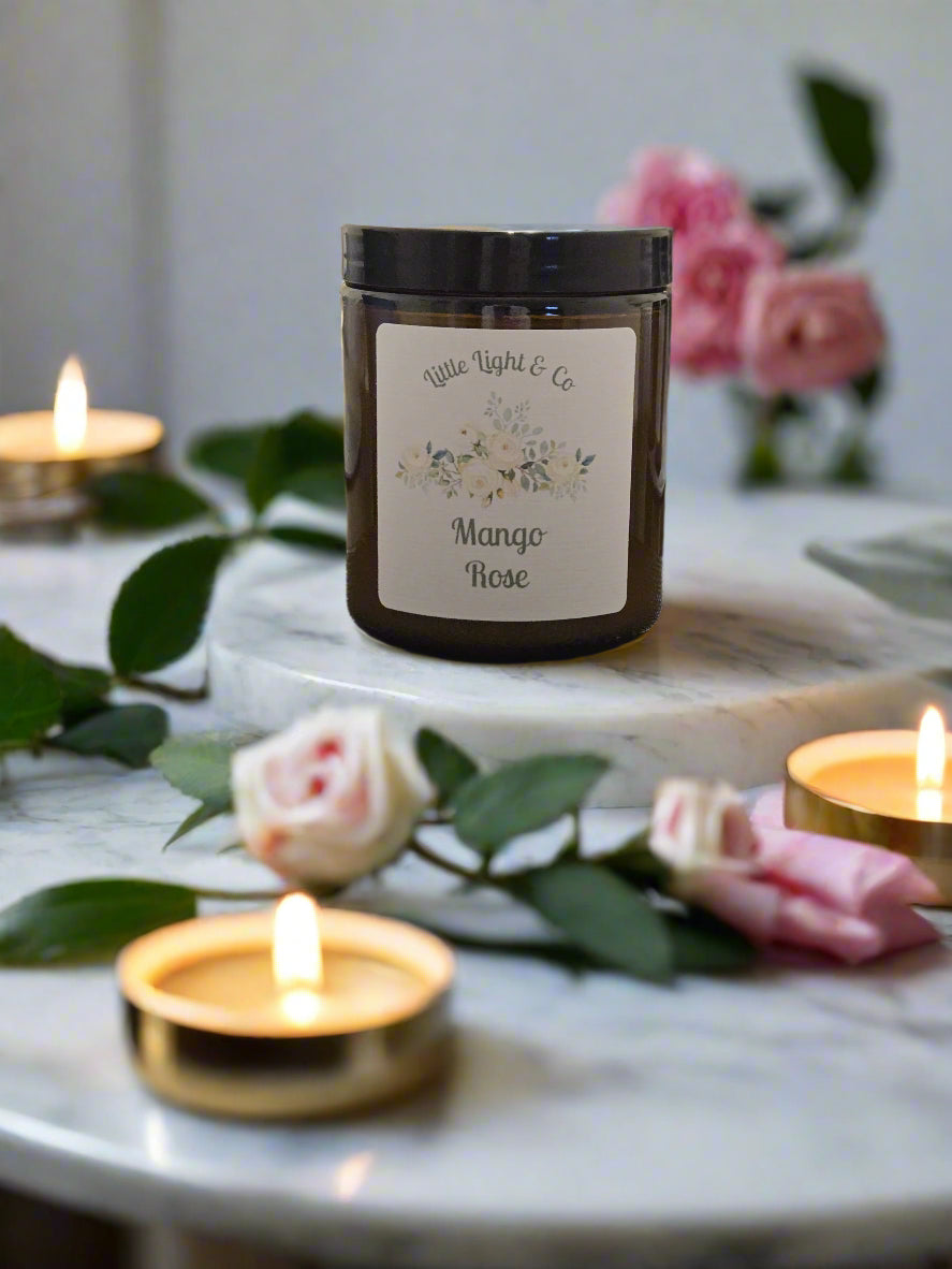 Mango rose scented candle in a reuseable amber jar little light & co