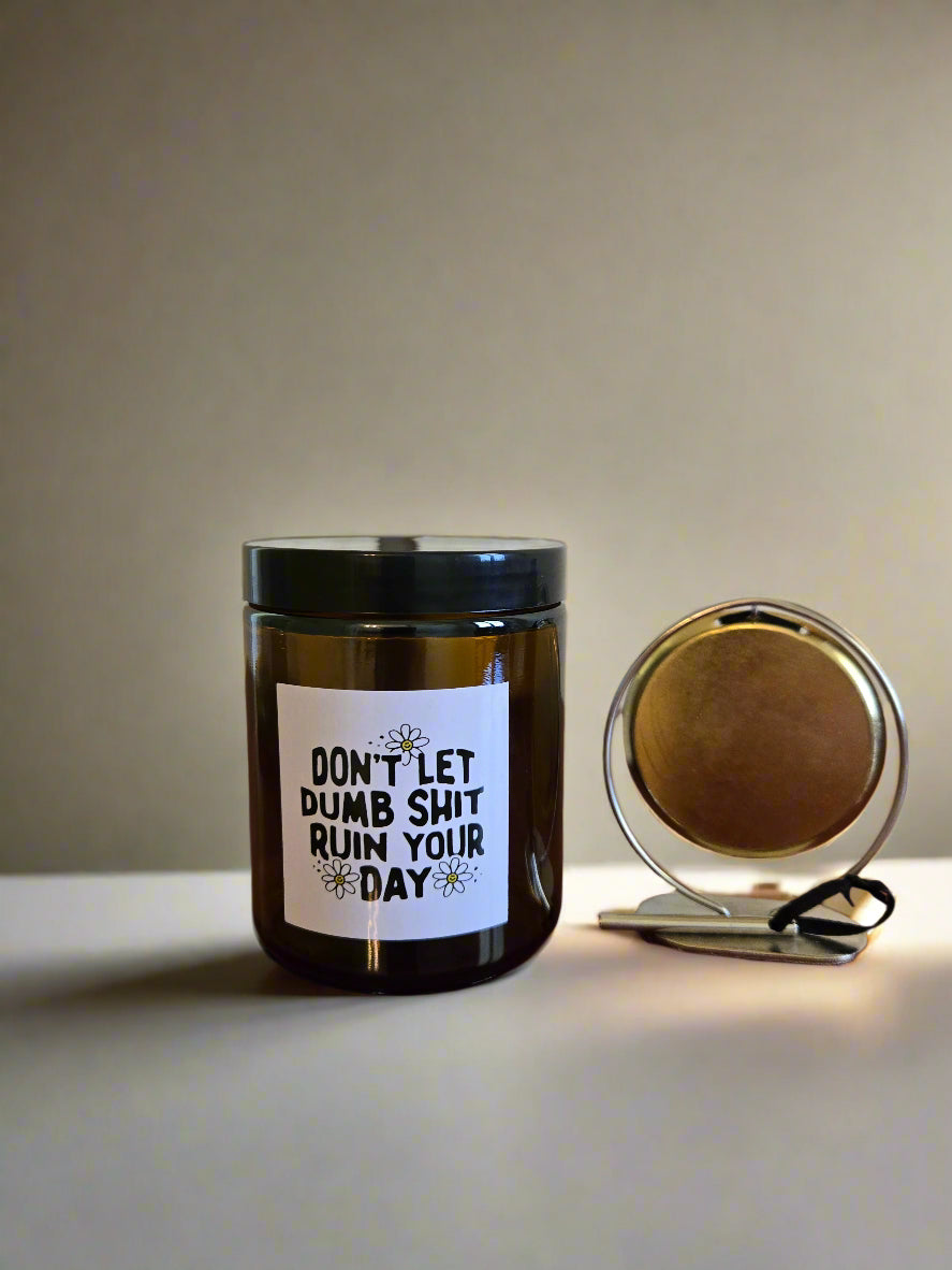 Small jar with a humorous label on a wooden surface