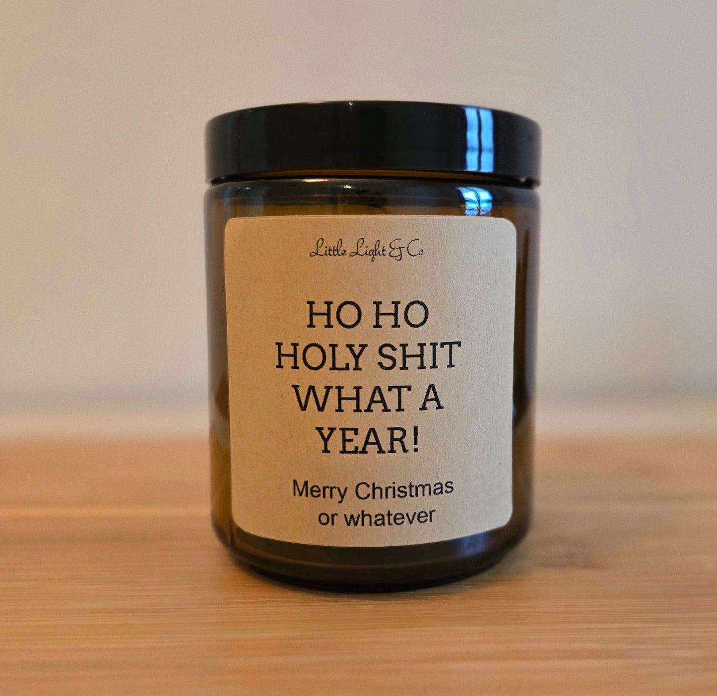 Candle with a humorous label on a wooden surface