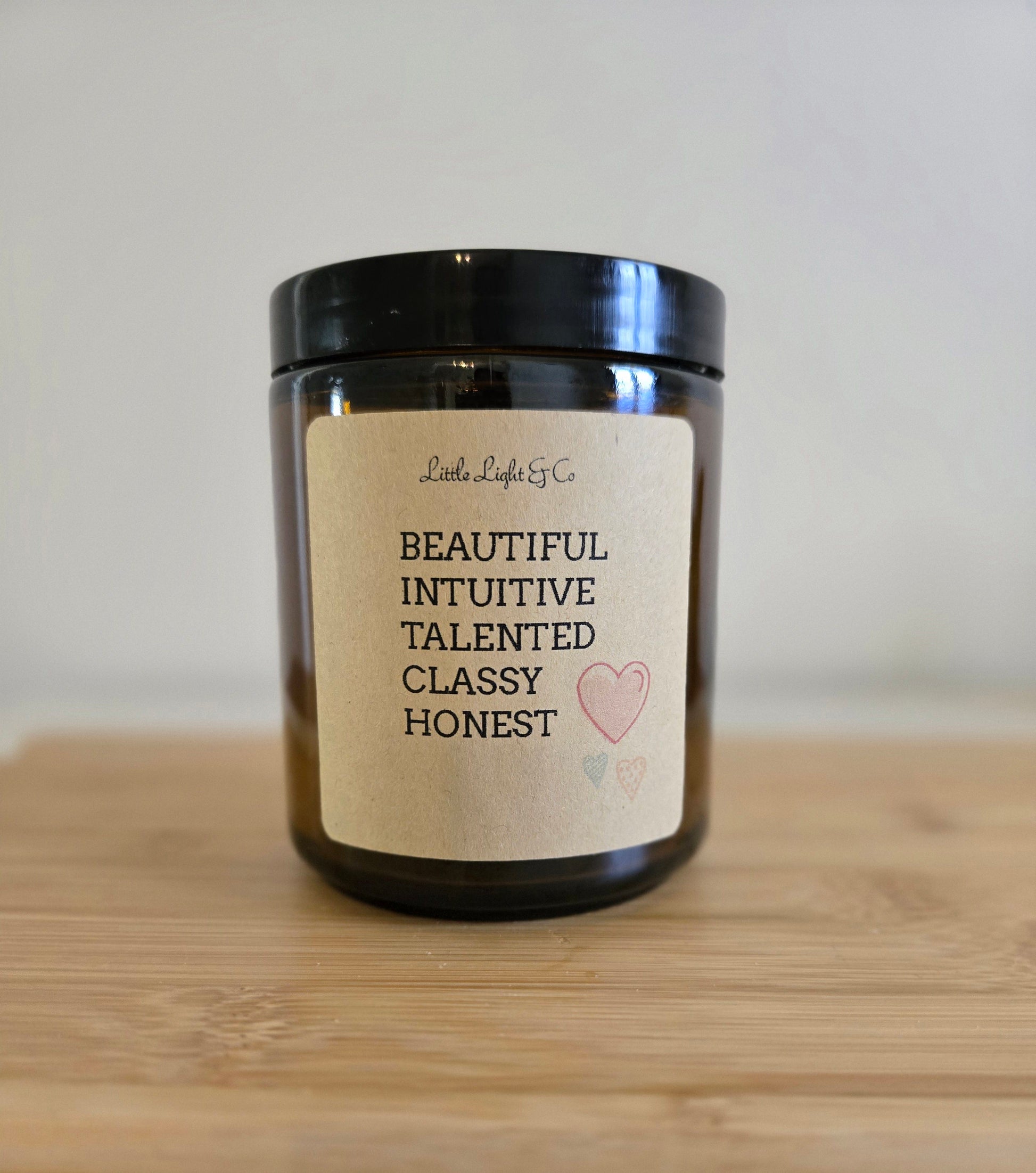 Candle with a label on a wooden surface